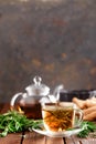 Rosemary tea in glass tea cup on rustic wooden table closeup. Herbal vitamin tea Royalty Free Stock Photo