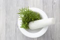 Rosemary in a white granite pestle and mortar. Royalty Free Stock Photo