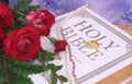 Roses With Bible and Wedding Rings on Wood Table Royalty Free Stock Photo