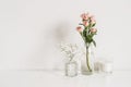 Roses, gypsophila and candle on table wall background. Romantic mockup template. Elegant minimalist Royalty Free Stock Photo