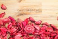 Roses petals on natural wooden table background. Love template for valentines day pink flowers at the bottom. Empty top. Royalty Free Stock Photo