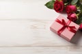 roses and pink gift box on white wooden background top view, valentines day floral template with copy space Royalty Free Stock Photo