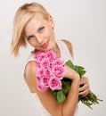 These roses are so pretty. Portrait of an attractive young woman holding a bunch of flowers. Royalty Free Stock Photo