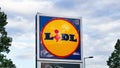 Roses, Spain - September 13, 2021. Lidl brand logo sign against cloudy sky. Lidl is a popular German supermarket chain of stores