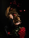 Roses for Valentines day. Holiday birthday present. Beautiful seductive woman holding large bouquet of red roses on Royalty Free Stock Photo