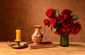 Roses in a vase, books and candles Royalty Free Stock Photo