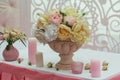 Roses in a vase and candles on the table Royalty Free Stock Photo