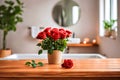 Roses in a vase and a towel on a wooden deck table, on a blurred bathroom background. Royalty Free Stock Photo