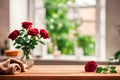 Roses in a vase and a towel on a wooden deck table, on a blurred bathroom background. Royalty Free Stock Photo