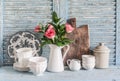 Roses in a white pitcher, vintage crockery on blue wooden rustic background. Kitchen still life in vintage country style. Flat lay Royalty Free Stock Photo