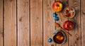 Rosh Hashana holiday background with honey, apples and chocolate on wooden table. View from above.