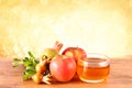 Rosh hashanah concept - apple honey and pomegranate over wooden table Royalty Free Stock Photo