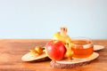 Rosh hashanah concept - apple honey and pomegranate over wooden table Royalty Free Stock Photo