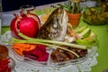 Rosh Hashanah, dish with the fish head, fruits and vegetables Royalty Free Stock Photo