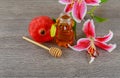rosh hashanah jewesh holiday concept - pomegranate honey pink lilies jewish food, symbol,