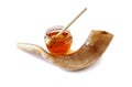 Rosh hashanah (jewesh holiday) concept - shofar (horn) and honey isolated on white. traditional holiday symbols. Royalty Free Stock Photo