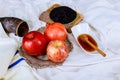 rosh hashanah jewesh holiday concept - shofar, torah book, honey, apple and pomegranate over wooden table. a kippah a yamolka Royalty Free Stock Photo