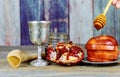 rosh hashanah jewesh holiday concept - shofar, torah book, honey, apple and pomegranate over wooden table. a kippah a yamolka Royalty Free Stock Photo