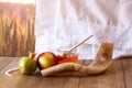 Rosh hashanah (jewesh holiday) concept - shofar, torah book, honey, apple and pomegranate over wooden table. traditional holiday Royalty Free Stock Photo