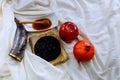 rosh hashanah jewesh holiday concept - shofar, torah book, honey, apple and pomegranate over wooden table. a kippah a yamolka Royalty Free Stock Photo