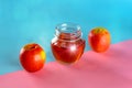 Honey and apples over festive blue pink background. Royalty Free Stock Photo
