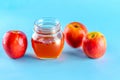 Honey and apples over blue background. Royalty Free Stock Photo