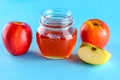 Honey and apples over blue background. Royalty Free Stock Photo