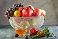 Rosh hashanah - jewish New Year holiday concept. Traditional symbols: Honey jar and fresh apples with pomegranate and basket with Royalty Free Stock Photo