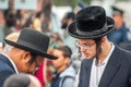 Rosh Hashanah, Jewish New Year 5777. Pilgrims in traditional festive clothes. Conversation between two Hasidic Jews.