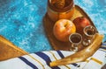 Rosh hashanah Jewish New Year holiday symbols shofar, honey, apple and pomegranate on a flat lay