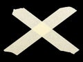 ÃÂ¡ross of pieces of masking tape isolated on a black Royalty Free Stock Photo