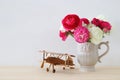 rosses in the vintage vase and old airplane toy Royalty Free Stock Photo