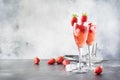 Rossini alcoholic cocktail with Italian sparkling wine, strawberry puree and ice in champagne glasses, place for text, selective