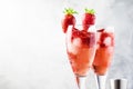 Rossini - italian alcoholic cocktail with sparkling wine, fresh strawberry puree and ice in champagne glasses, copy space,