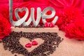 rosted coffee beans with heart chocolates red flowers and LOVE