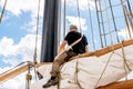 Rostock, Germany - August 2016: Sailor working on sailing ship. Royalty Free Stock Photo