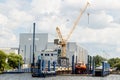 ROSTOCK, GERMANY - CIRCA 2016: A crane assists the construction of a yacht at small shipyard at the harbor of Rostock in Germany
