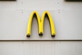 Rostock, Germany, January 26, 2024: Golden arches brand logo of Mac Donalds Corporation on a gray building facade in the city