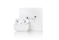 Apple AirPods Pro on a white background. Wireless headphones in a charging case and a box Royalty Free Stock Photo