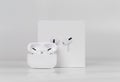 Apple AirPods Pro on a white background. Wireless headphones in a charging case and a box Royalty Free Stock Photo