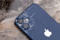 IPhone 12 on marble surface. Close-up of a smartphone with a broken case