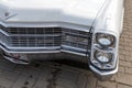 Headlights and radiator grill of a vintage white Cadillac Coupe de Ville at the retro car show Royalty Free Stock Photo