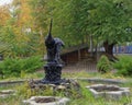 Two heron statues on a pedestal at a fountain in the autumn day