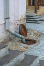 Drainpipe and manhole near the old church