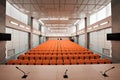 Rostrum with microphone and computer in conference hall. Orange color Royalty Free Stock Photo