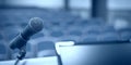 Rostrum with microphone and computer in conference room Royalty Free Stock Photo