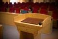 Rostrum with a microphone in a reference room with one person