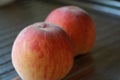 Rosy ripe Kuban peach close-up on a metal table