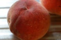 Rosy ripe Kuban peach close-up on a metal table