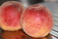 Rosy ripe Kuban peach close-up on a metal table
